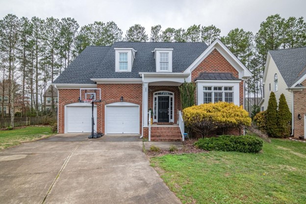 Brick two-story house with double garage and basketball hoop in driveway