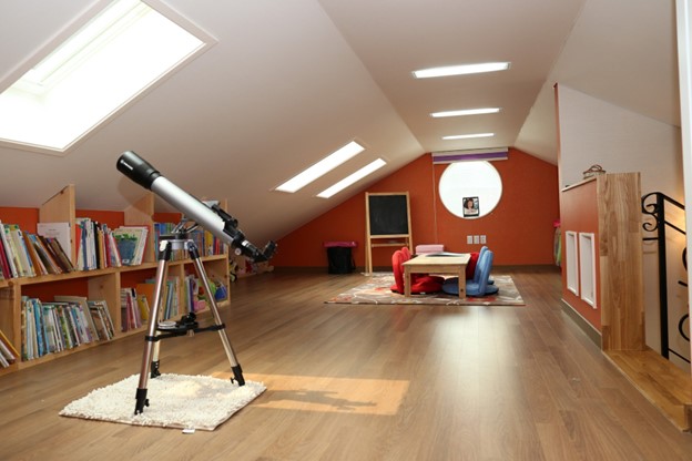 attic with window and telescope