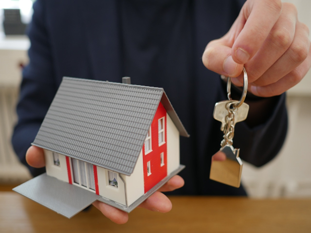 man holding house and key