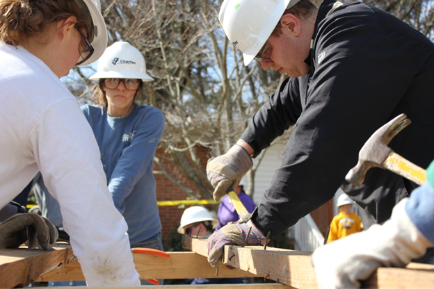 goup or people building a wooden frame