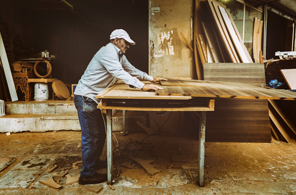 man working with wood on table