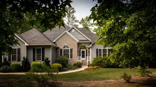 house with green lawn and trees