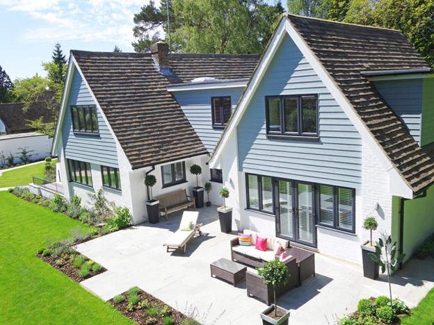 blue house with nice roof and patio