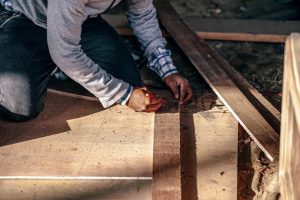 contractor measuring lumber