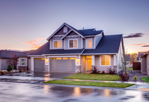 house with interior lights on after rain