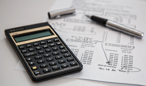 calculator and pen with paperwork