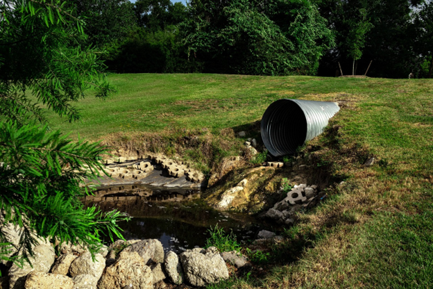 large pipe draining into pond