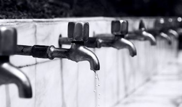 line of faucets with one leaking