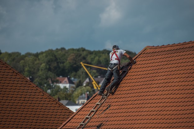 man fixing roof