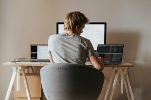 man at desk working on computer