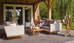 women seated on outdoor furniture talking