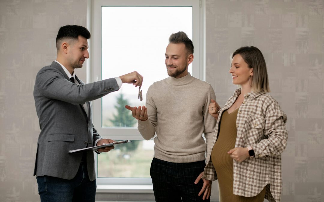 handing keys to young couple