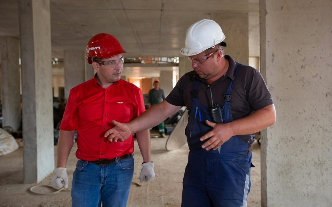 two construction workers discussing project