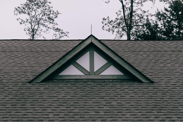 small roof peak with green wood trim