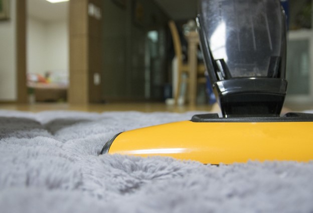 yellow vacuum on carpeting