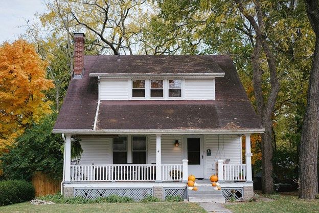 white house with porch and railing