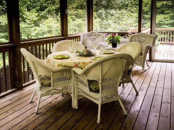 white wicker furniture on screened porch