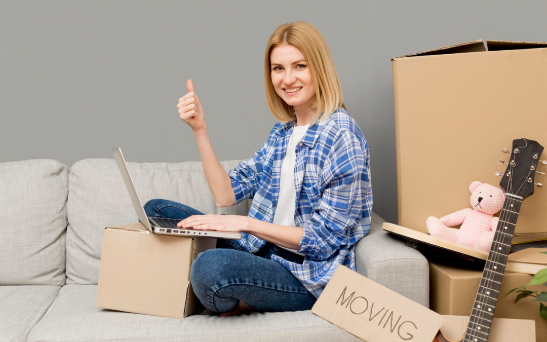 woman on a laptop preparing for moving