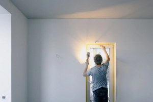 man installing new door