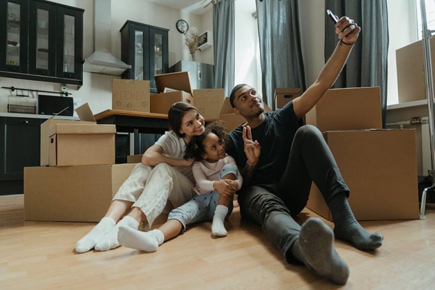 family taking selfie with moving boxes