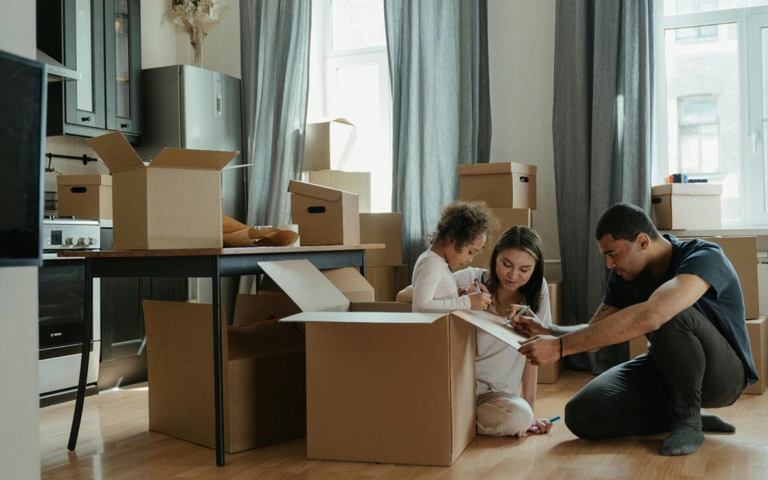 family sorting through moving boxes