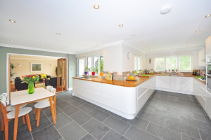 large kitchen with white cabinets and a grey tile floor