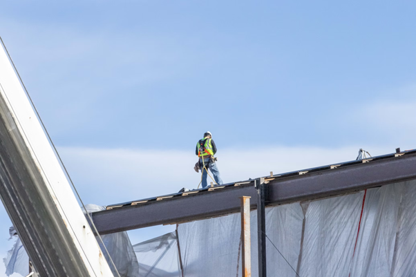 roofing contractor inspecting commercial roof