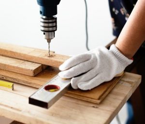 person drilling into wood