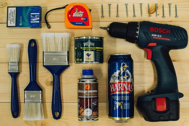 various home repair tools on piece of wood