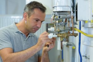 plumber working on pipes