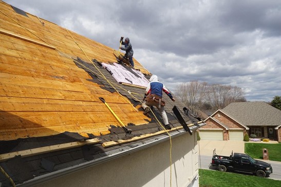 roofers tearing off old roof