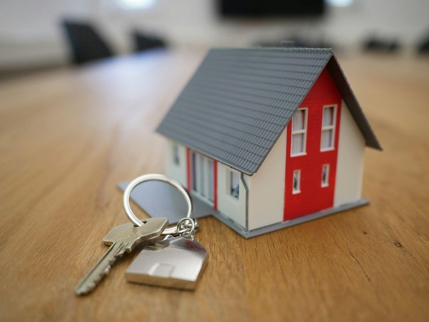 miniature house next keys on a key ring