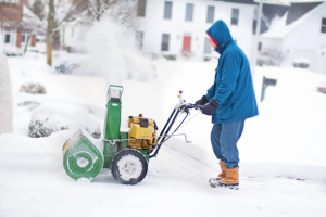 person using snowblower to remove snow