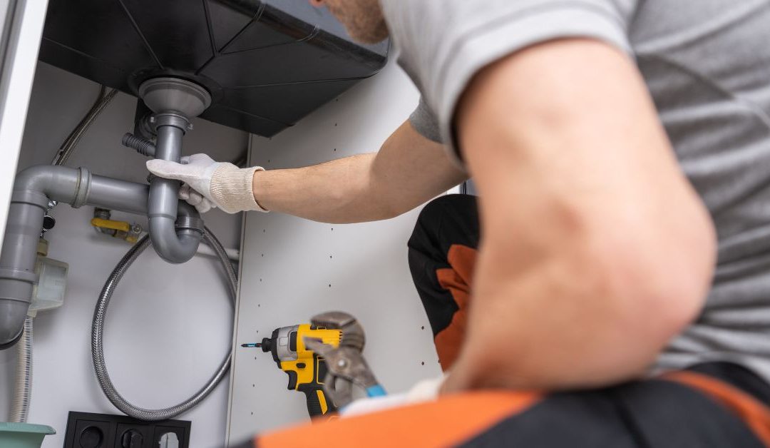 person working on sink drain repair