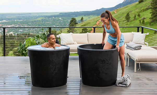 couple taking cold plunge in ice bath