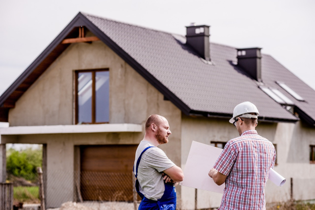 building contractor discussing house plans with homeowner