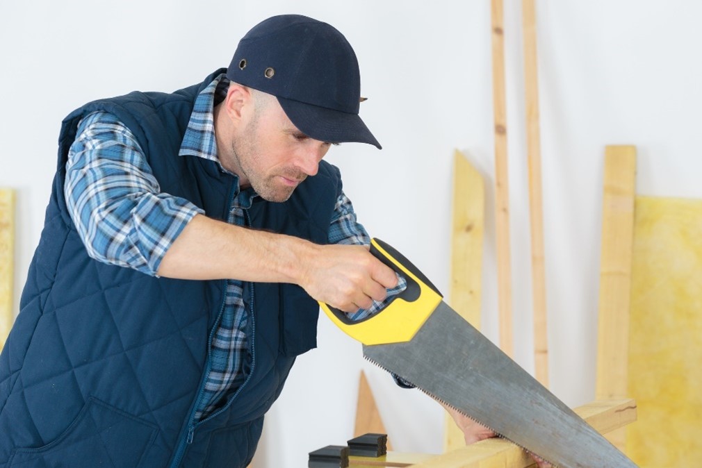 handyman sawing wood