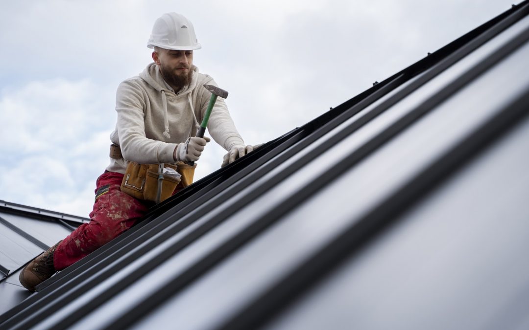 man working on metal roof installation