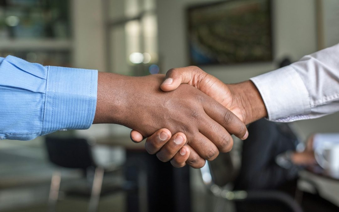 two men shaking hands after making a contract