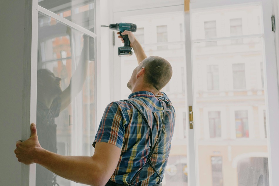 man installing new window