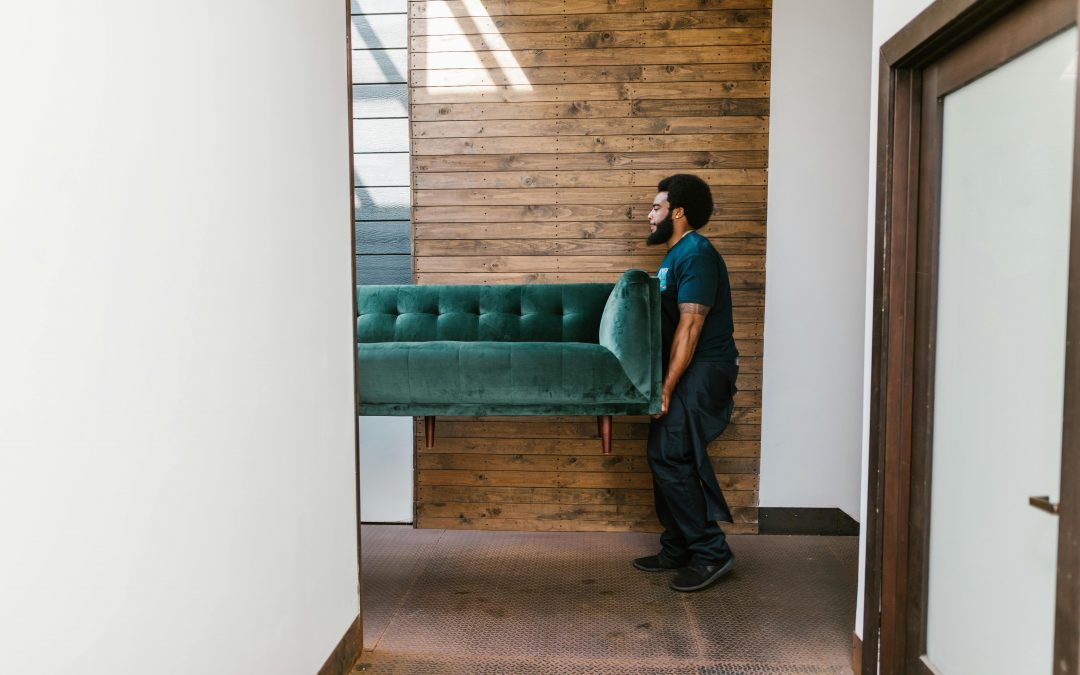 movers taking sofa to storage