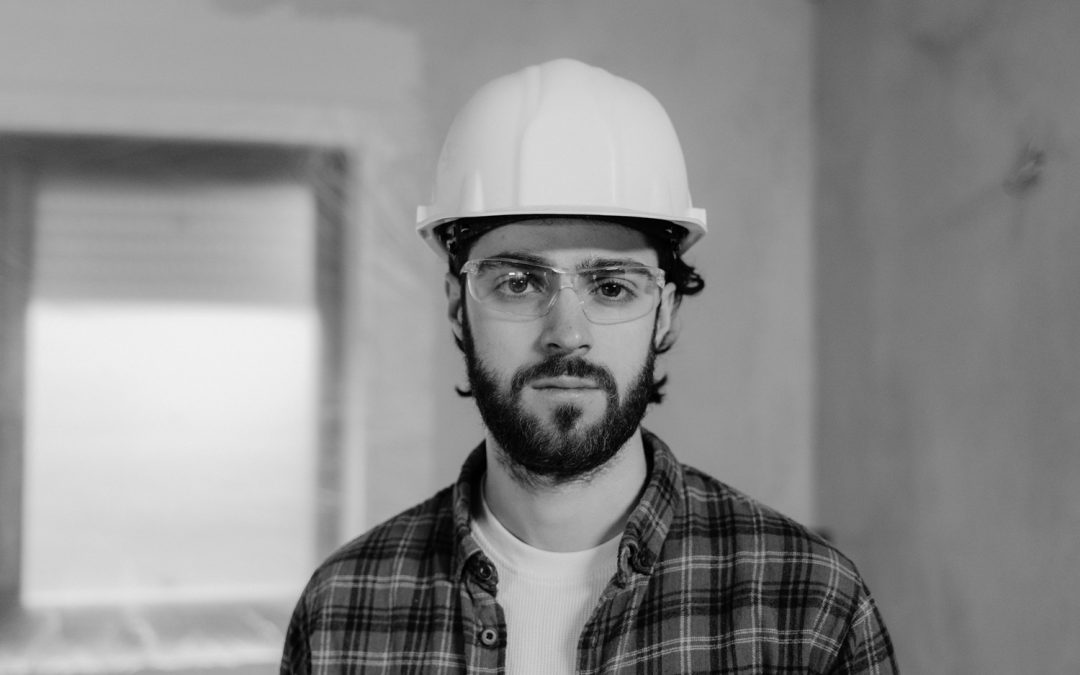 black and white image of contractor with hardhat