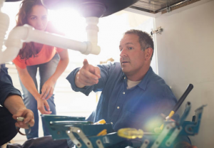 plumber talking to homeowner about plumbing repair