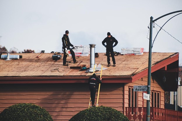 men working on replacing roof