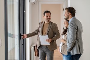 real estate agent showing home to couple