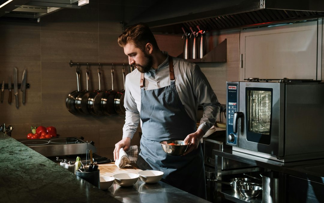 man standing in clean modern kitchen with high end cooking tools