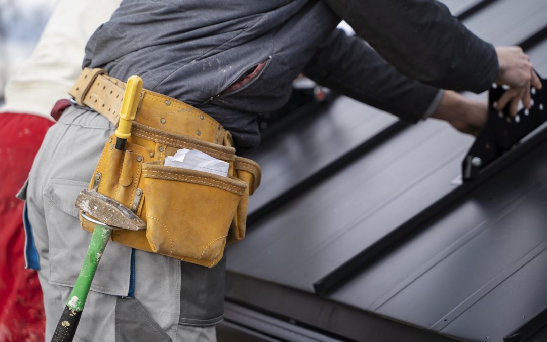 roofer installing metal roof