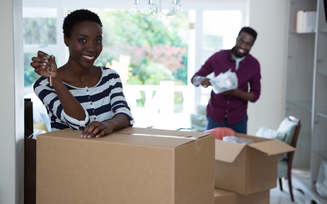 young couple packing moving boxes