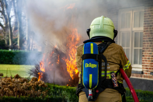 firefighter putting out house fire