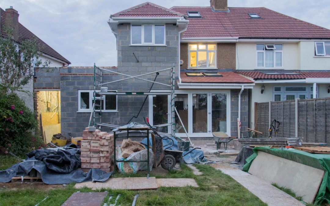 image of a home which has what appears to be a garage under construction in front of it